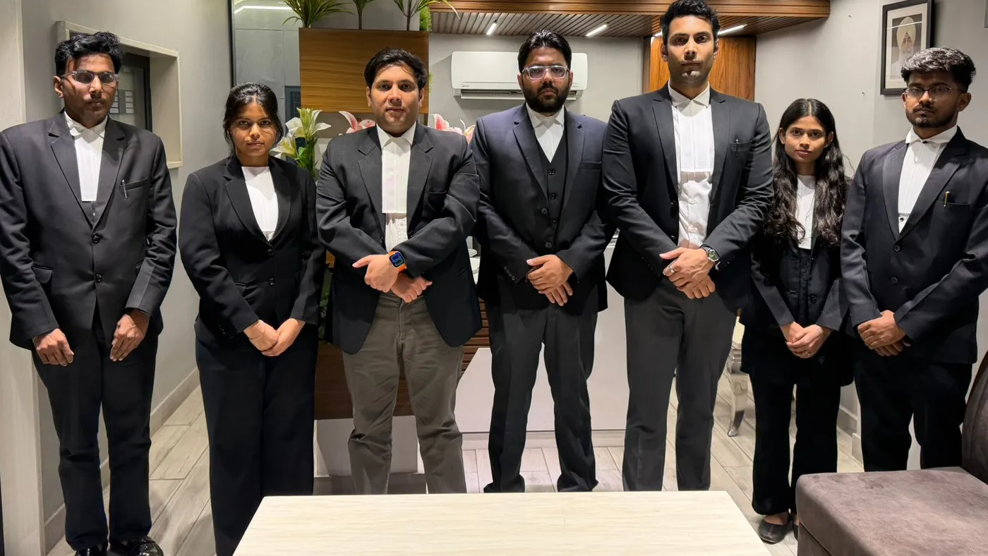 The Manuja Law Partners team, seven advocates in court dress, at the firm's chamber